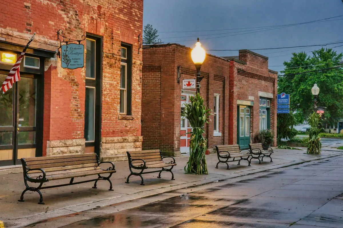 Brick storefronts and benches on a main street in downtown Sherman, TX