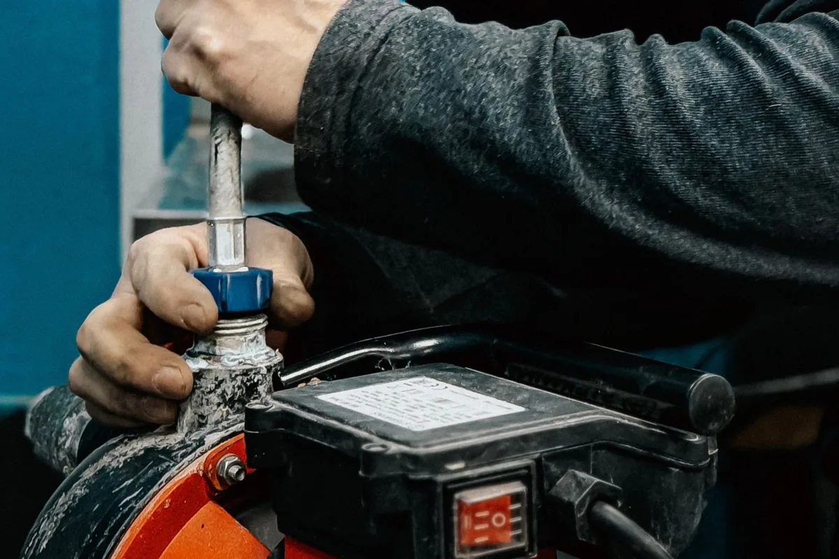 A technician connecting a water pump during an emergency callout in Sherman, TX