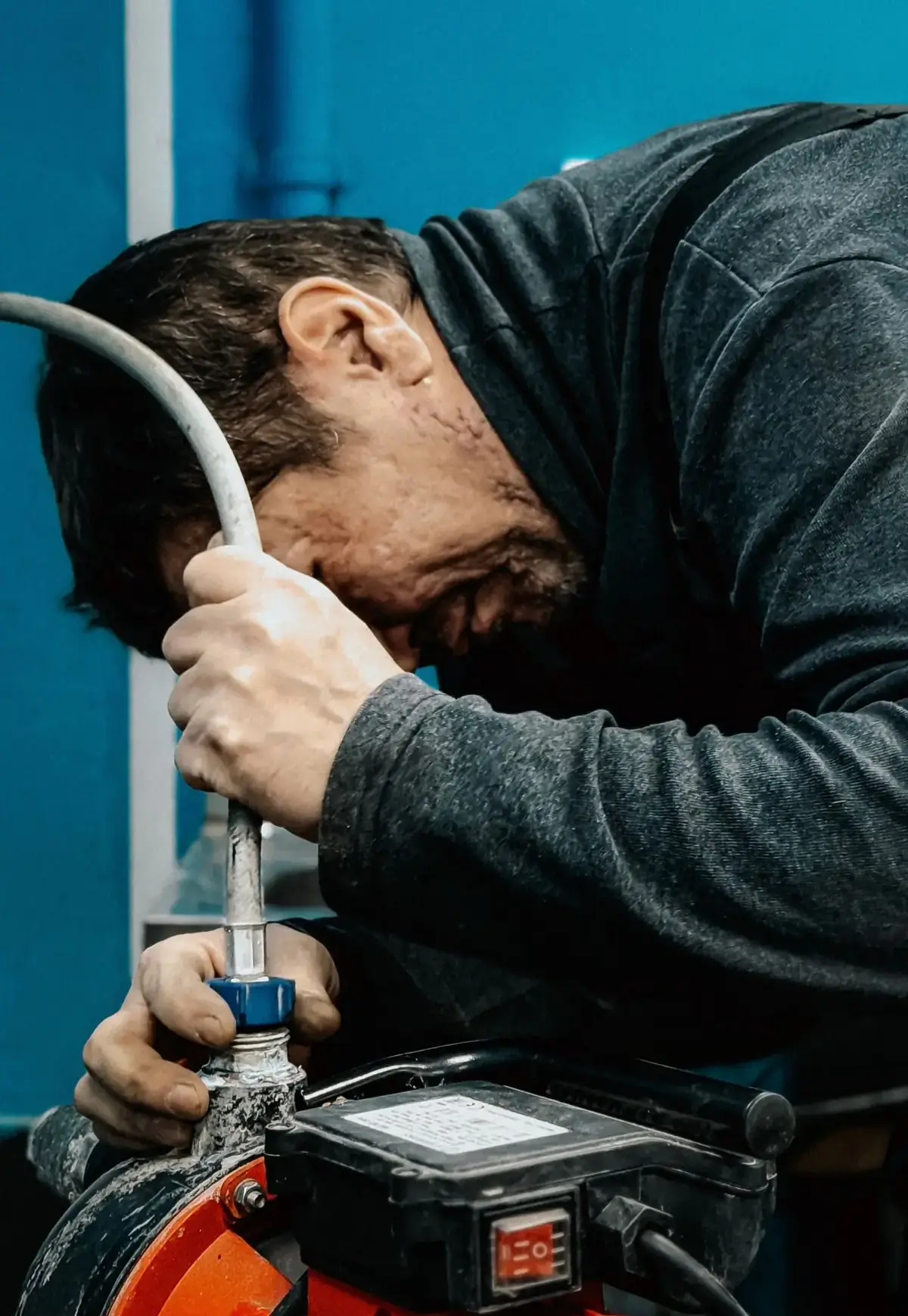 A technician repairing water heater equipment for a Sherman, TX homeowner